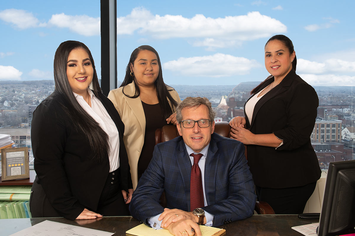group shot of attorney Michael Aquino and his staff members